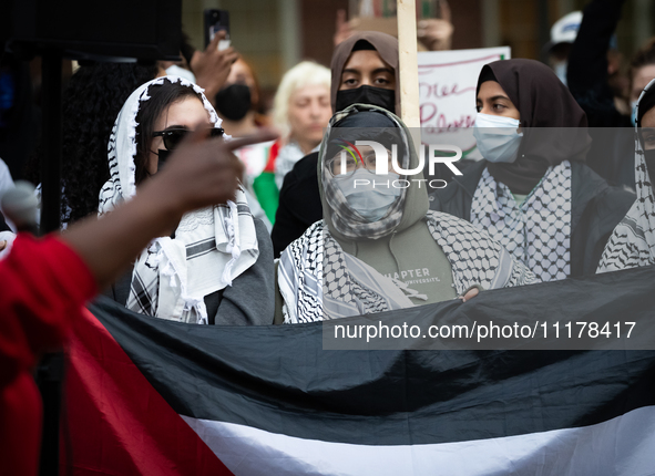 People rally at an encampment for Palestine set up by George Washington University students earlier in the day, in conjunction with other DC...