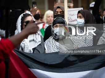 People rally at an encampment for Palestine set up by George Washington University students earlier in the day, in conjunction with other DC...