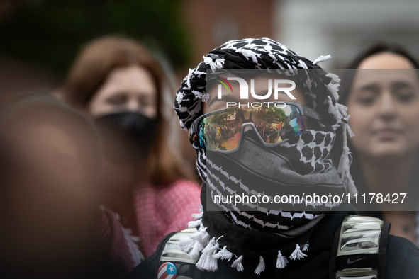 A demonstrator's sunglasses reflect the surrounding rally at an encampment for Palestine set up by George Washington University students in...