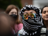 A demonstrator's sunglasses reflect the surrounding rally at an encampment for Palestine set up by George Washington University students in...