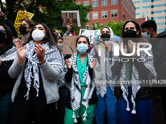 People rally at an encampment for Palestine set up by George Washington University students earlier in the day, in conjunction with other DC...