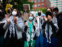 People rally at an encampment for Palestine set up by George Washington University students earlier in the day, in conjunction with other DC...