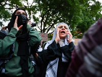 People rally at an encampment for Palestine set up by George Washington University students, in conjunction with other DC-area universities,...