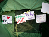 Signs hang on a tent at an encampment for Palestine set up by George Washington University students  in conjunction with other DC-area unive...