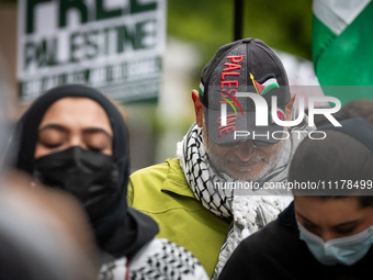 People rally at an encampment for Palestine set up by George Washington University students earlier in the day, in conjunction with other DC...