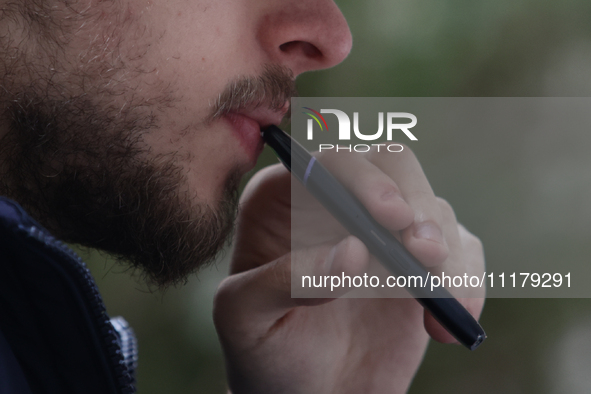 A person smokes an electronic cigarette in Krakow, Poland on April 9, 2022. 