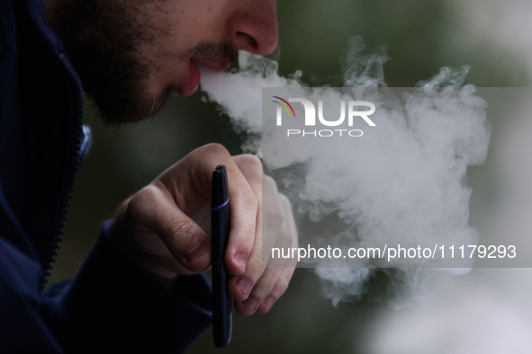 A person smokes an electronic cigarette in Krakow, Poland on April 9, 2022. 