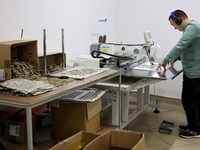 An employee is working in headphones at the Dzhavelina factory, which is manufacturing backpacks for the military in the Ivano-Frankivsk Reg...