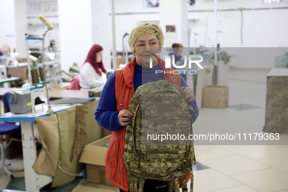 An employee is showing a backpack for the military at the Dzhavelina factory in Ivano-Frankivsk Region, Ukraine, on April 25, 2024. NO USE R...