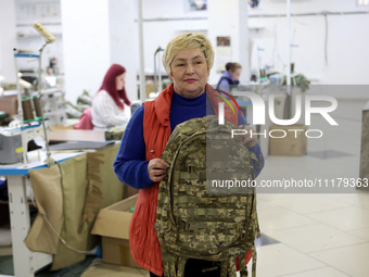 An employee is showing a backpack for the military at the Dzhavelina factory in Ivano-Frankivsk Region, Ukraine, on April 25, 2024. NO USE R...