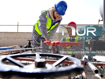 Technicians are inspecting a pipeline valve in the incineration workshop of the Zhangye Hazardous Waste (solid waste) disposal and resource...