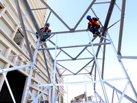 Construction workers are linking a steel tower at the construction site of the Zhangye Waste Disposal and Resource Utilization Center in Zha...