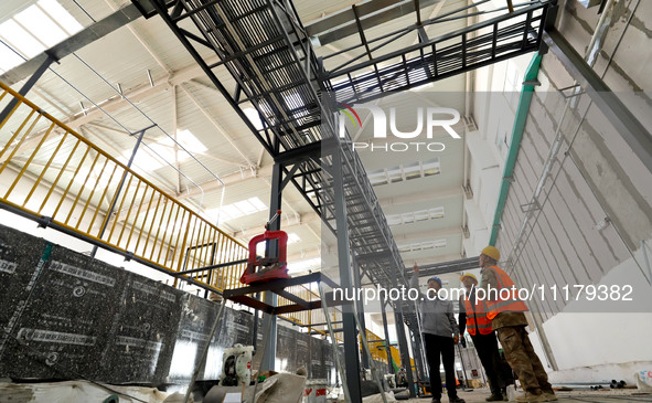 Technicians are checking the installed bridge at the biochemical center of the construction project for the Hazardous Waste (solid waste) Di...