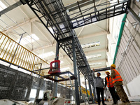 Technicians are checking the installed bridge at the biochemical center of the construction project for the Hazardous Waste (solid waste) Di...