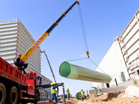 Construction workers are carrying out pipeline hoisting at the construction site of the Zhangye Waste Disposal and Resource Utilization Cent...