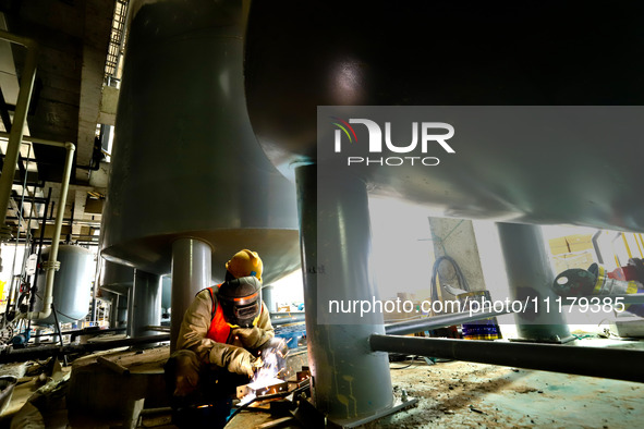 Construction workers are welding a pipeline at the construction site of the Zhangye Waste Disposal and Resource Utilization Center in Zhangy...