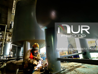 Construction workers are welding a pipeline at the construction site of the Zhangye Waste Disposal and Resource Utilization Center in Zhangy...