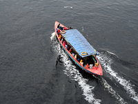 People are crossing the pitch-black polluted waters of the Buriganga River on a boat in Dhaka, Bangladesh, on April 26, 2024. Bangladesh has...