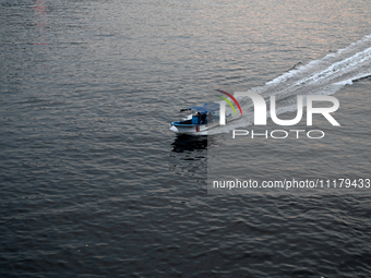 People are crossing the pitch-black polluted waters of the Buriganga River on a boat in Dhaka, Bangladesh, on April 26, 2024. Bangladesh has...