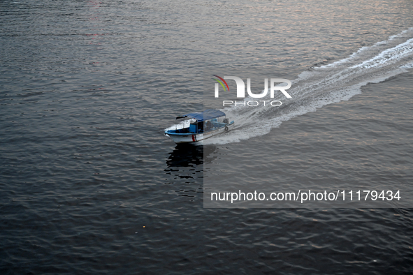 People are crossing the pitch-black polluted waters of the Buriganga River on a boat in Dhaka, Bangladesh, on April 26, 2024. Bangladesh has...