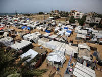 Palestinians are taking shelter in a tent camp in Deir Balah in the central Gaza Strip on April 26, 2024, as they flee their homes due to Is...