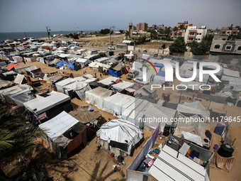 Palestinians are taking shelter in a tent camp in Deir Balah in the central Gaza Strip on April 26, 2024, as they flee their homes due to Is...