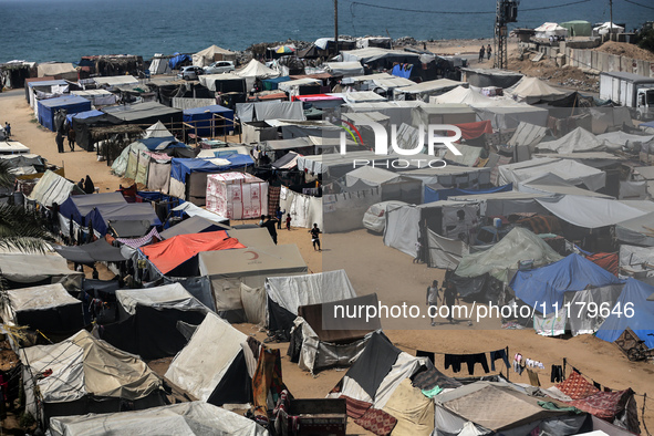 Palestinians are taking shelter in a tent camp in Deir Balah in the central Gaza Strip on April 26, 2024, as they flee their homes due to Is...