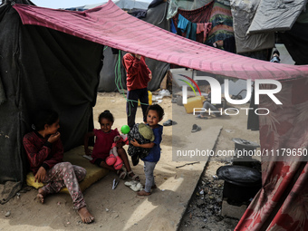 Palestinians are taking shelter in a tent camp in Deir Balah in the central Gaza Strip on April 26, 2024, as they flee their homes due to Is...