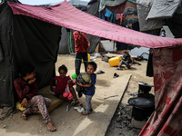 Palestinians are taking shelter in a tent camp in Deir Balah in the central Gaza Strip on April 26, 2024, as they flee their homes due to Is...