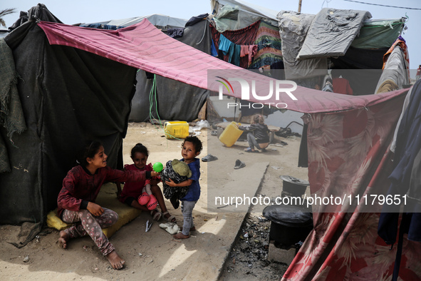 Palestinians are taking shelter in a tent camp in Deir Balah in the central Gaza Strip on April 26, 2024, as they flee their homes due to Is...