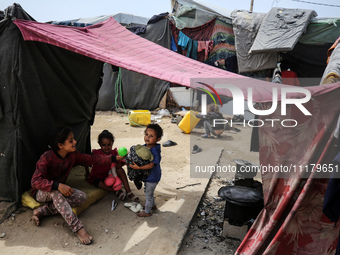 Palestinians are taking shelter in a tent camp in Deir Balah in the central Gaza Strip on April 26, 2024, as they flee their homes due to Is...