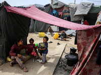 Palestinians are taking shelter in a tent camp in Deir Balah in the central Gaza Strip on April 26, 2024, as they flee their homes due to Is...