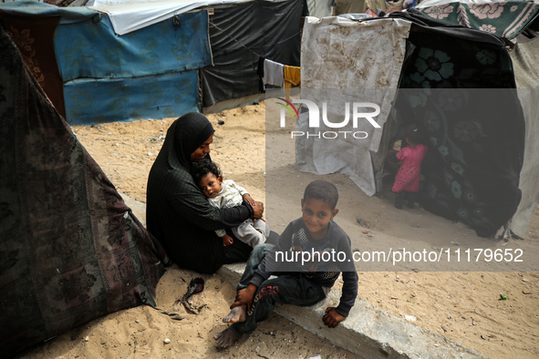 Palestinians are taking shelter in a tent camp in Deir Balah in the central Gaza Strip on April 26, 2024, as they flee their homes due to Is...