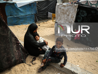 Palestinians are taking shelter in a tent camp in Deir Balah in the central Gaza Strip on April 26, 2024, as they flee their homes due to Is...