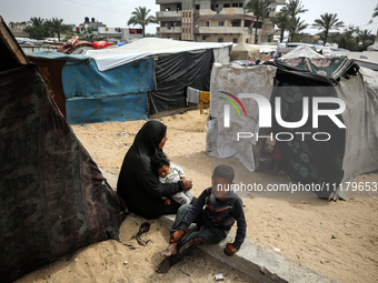 Palestinians are taking shelter in a tent camp in Deir Balah in the central Gaza Strip on April 26, 2024, as they flee their homes due to Is...