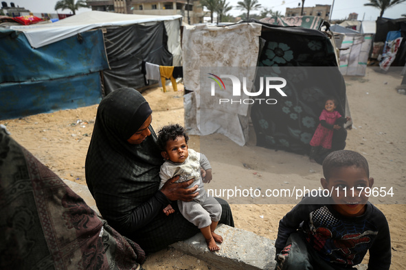 Palestinians are taking shelter in a tent camp in Deir Balah in the central Gaza Strip on April 26, 2024, as they flee their homes due to Is...