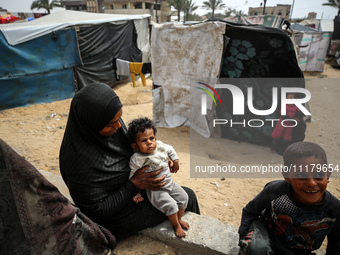 Palestinians are taking shelter in a tent camp in Deir Balah in the central Gaza Strip on April 26, 2024, as they flee their homes due to Is...