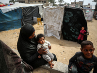 Palestinians are taking shelter in a tent camp in Deir Balah in the central Gaza Strip on April 26, 2024, as they flee their homes due to Is...