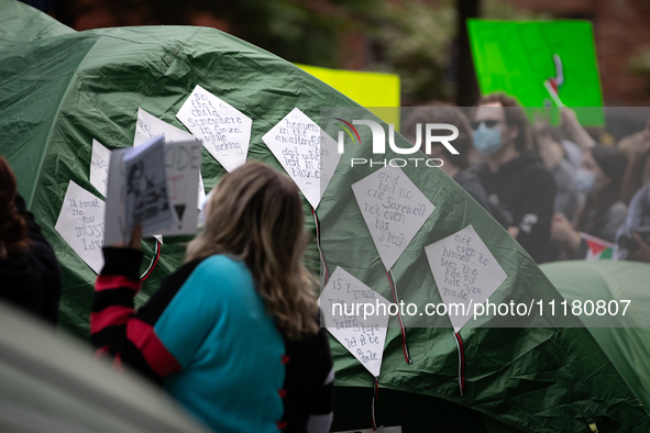 Kite-shaped signs containing the lines of Refaat Alareer's poem, "If I Must Die," written before he was killed by an Israeli airstrike, ador...