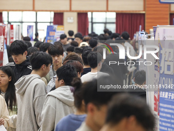 College students are choosing positions at a campus job fair in Huai'an, China, on April 27, 2024. (