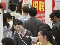 College students are choosing positions at a campus job fair in Huai'an, China, on April 27, 2024. (