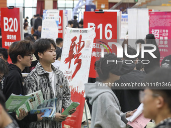 College students are choosing positions at a campus job fair in Huai'an, China, on April 27, 2024. (