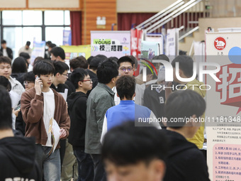 College students are choosing positions at a campus job fair in Huai'an, China, on April 27, 2024. (