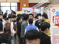 College students are choosing positions at a campus job fair in Huai'an, China, on April 27, 2024. (