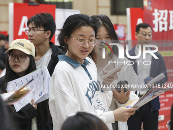 College students are choosing positions at a campus job fair in Huai'an, China, on April 27, 2024. (