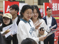 College students are choosing positions at a campus job fair in Huai'an, China, on April 27, 2024. (