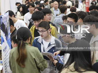 College students are choosing positions at a campus job fair in Huai'an, China, on April 27, 2024. (