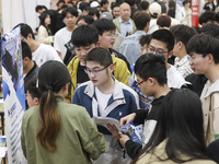 College students are choosing positions at a campus job fair in Huai'an, China, on April 27, 2024. (