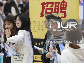 College students are choosing positions at a campus job fair in Huai'an, China, on April 27, 2024. (