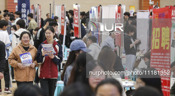 College students are choosing positions at a campus job fair in Huai'an, China, on April 27, 2024. 